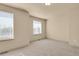 Carpeted bedroom with natural light from two windows, neutral walls, and flush mount lighting at 24269 E Arapahoe Pl, Aurora, CO 80016