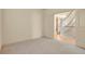 Neutral-toned bedroom featuring carpet, adjacent to a staircase with white railings, and a closed white door at 24269 E Arapahoe Pl, Aurora, CO 80016