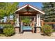 Inviting community pool entrance with stone pillars, lifeguard, and clear blue swimming water at 24269 E Arapahoe Pl, Aurora, CO 80016
