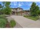 Beautiful two-story home boasts a three-car garage, lush lawn and attractive stone and wood finishes at 24269 E Arapahoe Pl, Aurora, CO 80016