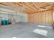 Empty two car garage featuring exposed framing, concrete floors, and a door leading to the house at 24269 E Arapahoe Pl, Aurora, CO 80016