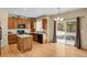 Warm kitchen featuring wood cabinets, granite countertops, stainless steel appliances and a sliding glass door at 24269 E Arapahoe Pl, Aurora, CO 80016