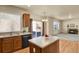 Kitchen island with view of sink, dishwasher, and sliding glass doors to the exterior at 24269 E Arapahoe Pl, Aurora, CO 80016