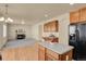 Open floor plan showcasing kitchen island flowing into living room with fireplace at 24269 E Arapahoe Pl, Aurora, CO 80016