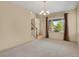 Bright living room featuring neutral carpet, a large window with curtains, and a staircase leading to the upper level at 24269 E Arapahoe Pl, Aurora, CO 80016