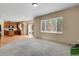 Open concept living room and kitchen area featuring neutral carpet, wood flooring, and a sliding glass door at 24269 E Arapahoe Pl, Aurora, CO 80016