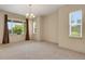 Large living room with neutral carpet, two large windows and window coverings, and neutral colored walls at 24269 E Arapahoe Pl, Aurora, CO 80016