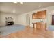 Open concept living area with fireplace, tan walls, and wood floors at 24269 E Arapahoe Pl, Aurora, CO 80016