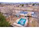 An aerial view of a neighborhood showcasing homes, streets, and natural landscape in the background at 6410 S Kendall St, Littleton, CO 80123