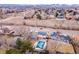 Aerial view of the homes in a residential area, pool with cover, and a mountain backdrop at 6410 S Kendall St, Littleton, CO 80123