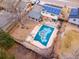 Aerial view of backyard pool with patio, home with solar panels and surrounding landscape at 6410 S Kendall St, Littleton, CO 80123