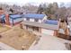 Aerial view of a charming two-story house with solar panels and well-maintained landscaping at 6410 S Kendall St, Littleton, CO 80123