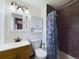 This bathroom features a vanity, tiled shower with curtain, and storage at 6410 S Kendall St, Littleton, CO 80123