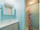 This bathroom features a shower and vanity with storage at 6410 S Kendall St, Littleton, CO 80123