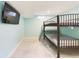 This finished basement bedroom features a bunkbed and a TV at 6410 S Kendall St, Littleton, CO 80123