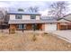 Inviting two-story home featuring solar panels, brick accents, and an attached garage at 6410 S Kendall St, Littleton, CO 80123