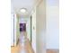 Bright hallway with wood floors leads to a living area with a fireplace at 6410 S Kendall St, Littleton, CO 80123