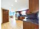 Well-lit kitchen showcasing stainless steel appliances, dark cabinets, and hardwood floors at 6410 S Kendall St, Littleton, CO 80123