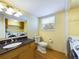 Bathroom and Laundry room featuring a sink with dark countertop and washer/dryer at 6410 S Kendall St, Littleton, CO 80123