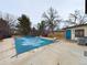 Backyard pool area with a pool cover, patio, and landscaping at 6410 S Kendall St, Littleton, CO 80123