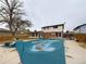 Backyard covered pool with patio area, trees, and home exterior in the background at 6410 S Kendall St, Littleton, CO 80123