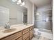 Bright bathroom with double sinks, granite countertop, and a tiled glass-enclosed shower at 3230 Boulder Cir # 101, Broomfield, CO 80023