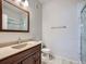 Well-lit bathroom featuring granite countertop and a shower with glass doors at 3230 Boulder Cir # 101, Broomfield, CO 80023