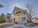 Exterior view of a multi-story home with well-maintained landscaping and a private balcony at 3230 Boulder Cir # 101, Broomfield, CO 80023