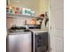 Convenient laundry room equipped with modern washer and dryer units and shelving at 3230 Boulder Cir # 101, Broomfield, CO 80023