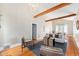 Bright living room with hardwood floors, beamed ceilings, neutral walls, and stylish furnishings, creating an inviting atmosphere at 5326 Lowell Blvd, Denver, CO 80221