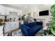 Modern living space with a sleek kitchen, cozy blue sofa, and a stylish bar area at 5326 Lowell Blvd, Denver, CO 80221