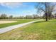Picturesque park featuring a walking path, baseball field, and lush green grass with mature trees at 5326 Lowell Blvd, Denver, CO 80221