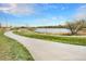 Scenic walking path along a tranquil lake with lush greenery and a clear blue sky backdrop at 5326 Lowell Blvd, Denver, CO 80221