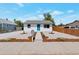 Front view of charming house with teal door and landscaping at 3401 W Virginia Ave, Denver, CO 80219