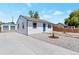 Newly remodeled home with gravel landscaping and driveway at 3401 W Virginia Ave, Denver, CO 80219