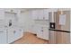 Modern kitchen with white shaker cabinets and stainless steel appliances at 3401 W Virginia Ave, Denver, CO 80219