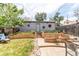 Beautiful backyard with stone patio, raised garden beds, and decorative lighting at 1844 S Lincoln St, Denver, CO 80210