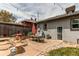 Outdoor dining on the patio with a shade umbrella and lush landscaping at 1844 S Lincoln St, Denver, CO 80210