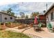 The backyard features a stone patio, string lights, and a manicured lawn at 1844 S Lincoln St, Denver, CO 80210