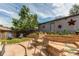 Landscaped backyard with patio, raised planters, seating, and lighting at 1844 S Lincoln St, Denver, CO 80210