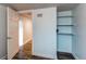 Basement hallway with an open door and built in shelving at 1844 S Lincoln St, Denver, CO 80210