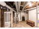 Unfinished basement featuring mechanicals, exposed ductwork, and storage space at 1844 S Lincoln St, Denver, CO 80210