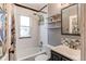 Bathroom featuring a tub, shower, sink, and shelving for storage at 1844 S Lincoln St, Denver, CO 80210