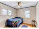 Bedroom featuring hardwood floors, two windows and a ceiling fan at 1844 S Lincoln St, Denver, CO 80210