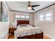 Cozy bedroom featuring a ceiling fan, hardwood floors, and a comfortable bed with stylish bedding at 1844 S Lincoln St, Denver, CO 80210