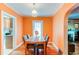 Bright dining room featuring orange colored walls and hardwood floors at 1844 S Lincoln St, Denver, CO 80210