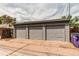 Three-car detached garage with ample parking space on a paved driveway at 1844 S Lincoln St, Denver, CO 80210