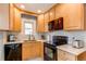 Well-lit kitchen featuring wooden cabinets, modern appliances, and ample counter space at 1844 S Lincoln St, Denver, CO 80210