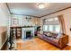 Comfortable living room featuring a fireplace, hardwood flooring, and large windows at 1844 S Lincoln St, Denver, CO 80210