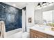 Stylish bathroom featuring navy blue tiles in shower and a modern vanity at 556 Monroe St, Denver, CO 80206